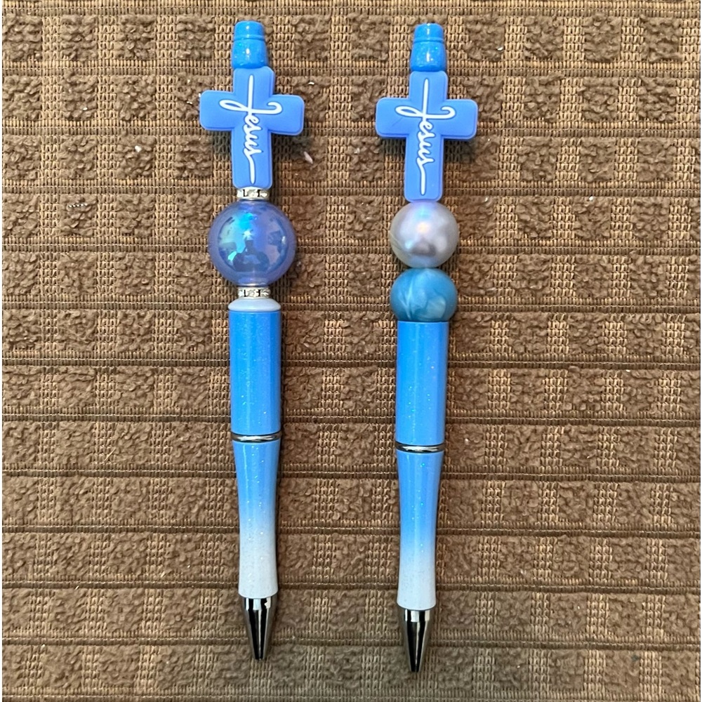 Handmade Beaded Pens. 2 Light Blue Crosses with Jesus wrote on them.